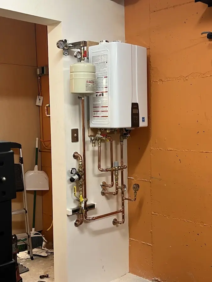 Plumbing technician inspecting water heater connections in Pearl City